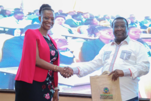 Safaricom PLC, Chief Financial Services Officer, Esther Waititu shares a light moment with Mr. Charles M. Ringera, HELB CEO during the official launch of a Mobile payment solution for HELB at the Lake Naivasha Resort.