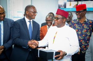 From the left NCBA Group Executive Director & CFO, David Abwoga gifting H.E Kenneth Lusaka, Governor Bungoma County for his support during the NCBA Chwele branch opening in Bungoma County.