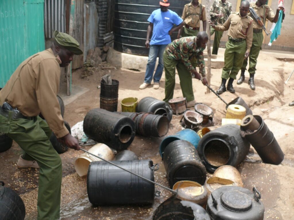 Police officers in Maralal town pour and destroy illicit brew in a past crackdown