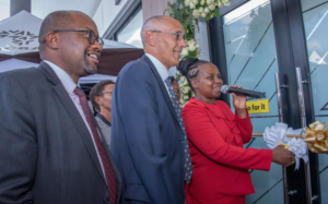 (L– R) NCBA Group Director, Retail Banking Tirus Mwithiga and Makueni Deputy Governor H.E. Hon Lucy Mulili as she signs the guest book during the grand opening ceremony of the new NCBA Wote branch in Makueni County.