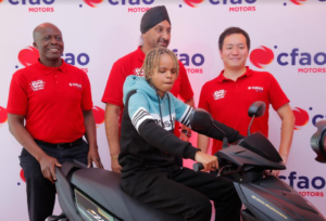 From Left: From Left: CFAO Motors Kenya Deputy Managing Director - Toyota & Yamaha Division Joshua Anya, Managing Director, Arvinder Reel and Nakamura San - Yamaha East Africa Regional Office Manager award Alma Ndila with a new Yamaha Scooter motorbike. She emerged as the winner of the 2023 Yamaha Motor Road Music Challenge.