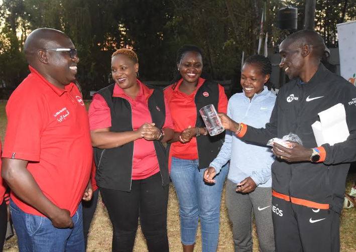 Absa Bank Kenya Regional Manager for the Rift Valley Cluster Julius Songok, Marketing Manager - Business Banking Naomi Njagua and Communications Manager Yvonne Nkirote with three-time 1500m Olympic champion Faith Kipyegon and two-time Olympic marathon champion Eliud Kipchoge at the Kaptagat Training Camp where the Bank organised a financial management and nutrition program for 105 athletes in preparation for the upcoming Absa Sirikwa Classic World Cross Country Tour scheduled for Saturday, February 22, at Lobo Village in Eldoret.