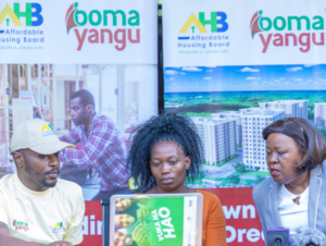 CS Alice Wahome looks on as Milka Moraa is onboarded to the Affordable Housing programme through Boma Yangu