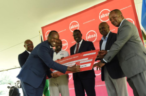 Absa Bank Kenya MD & CEO Abdi Mohamed signs the cheque for the sponsorship of the Magical Kenya Open where the bank committed a sponsorship of KES. 60 million towards Magical Kenya Open set to take place from February 20 - 23, 2025. Looking on are (L-R) Absa Bank Kenya Consumer Banking Director Moses Muthui, Magical Kenya Open Tournament Director Patrick Obath, State Department of Sports Principal Secretary Eng. Peter Tum, Kenya Open Golf Limited Chairman Peter Kanyago, and Absa Bank Kenya CFO Yusuf Omari.