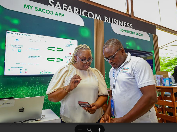 Cynthia Kropac, the Chief Enterprise Business Officer at Safaricom (left), demonstrates to Robert Kariuki of Ports Sacco (right) how the MySacco App works during the exhibition at the 10th Annual Sacco Leaders Convention in Mombasa.