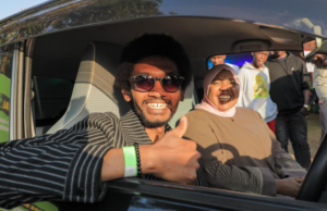 Joseph Kinyua sits inside his brand-new car alongside Fawzia Ali Kimanthi, Safaricom’s Chief Consumer Business Officer, after winning through the Wai Ndai campaign.