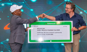 Peter Ndegwa - Safaricom CEO (left), hands over a cheque to Christian Lambrechts, Executive Director of Rhino Ark (Right) during the official sponsorship announcement by Safaricom for 2025 Rhino Charge event at Safaricom Head Quarters in Nairobi.