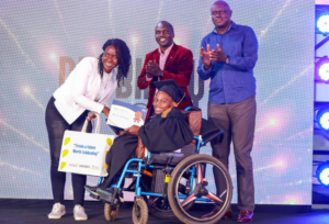 From left, nominated senator Krystal Asige, USIU-Africa DVC-Student Life, Dr. Victor Boiyo and KBL MD, Mark Ocitti awards Brenda Mwenda Marete a completion certificate after successfully completing a digital marketing course at the USIU university. KBL introduced the DIGIBILITY program that focuses on empowering PWDs.