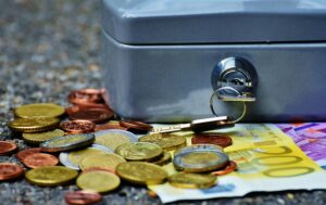 Banknotes and Coins Beside Gray Safety Box. Best Money Market Funds in Kenya